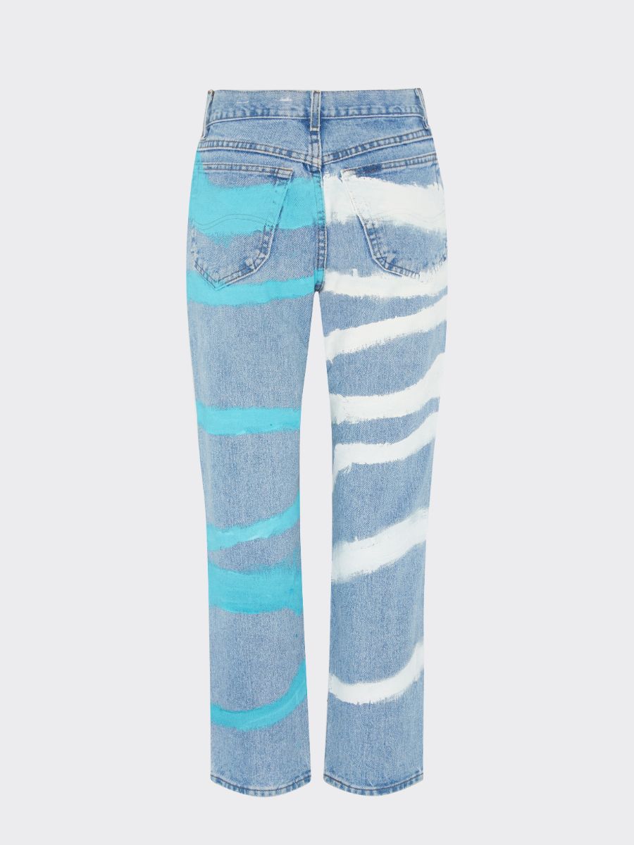 Fanfare Label sustainable women’s clothing brand UK. Our upcycled jeans are high-waisted, blue denim and made from recycled denim. We decorate every jean with a white & blue paint design.