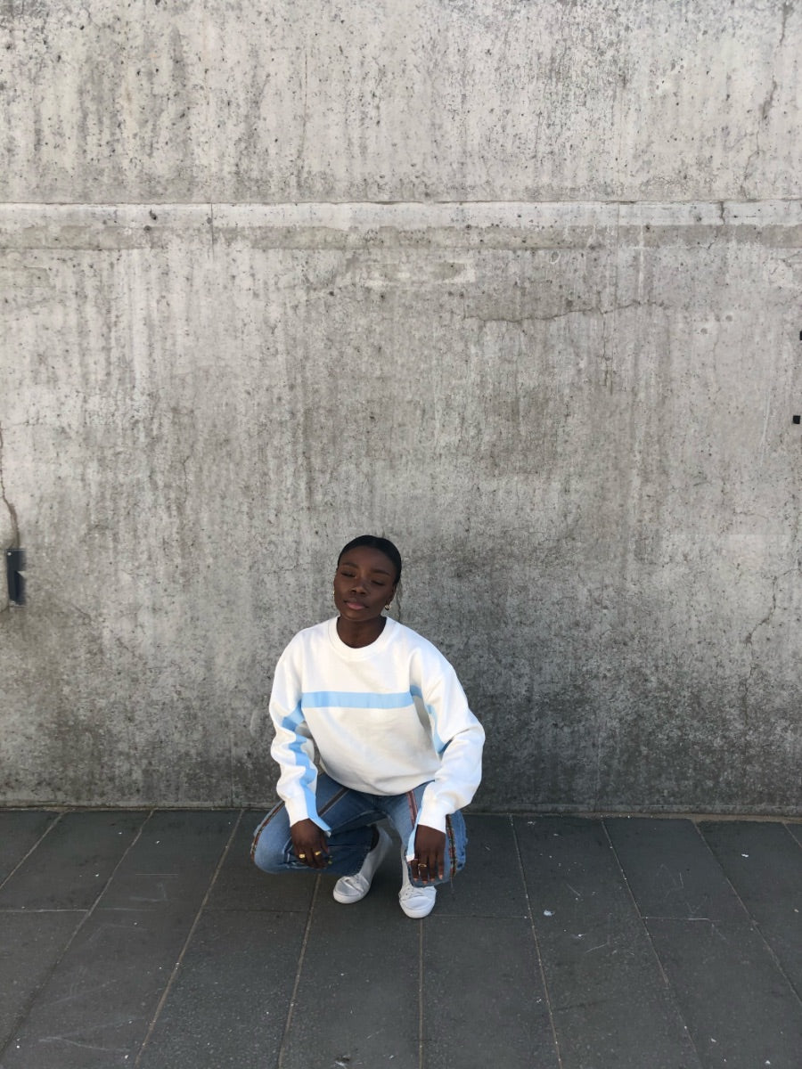 100% Gots certified organic cotton jumper in white with an blue stripe across the chest & down the arms. Made by sustainable clothing brand Fanfare Label.