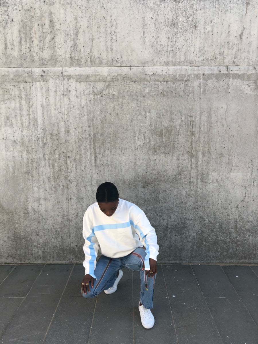 100% Gots certified organic cotton jumper in white with an blue stripe across the chest & down the arms. Made by sustainable clothing brand Fanfare Label.