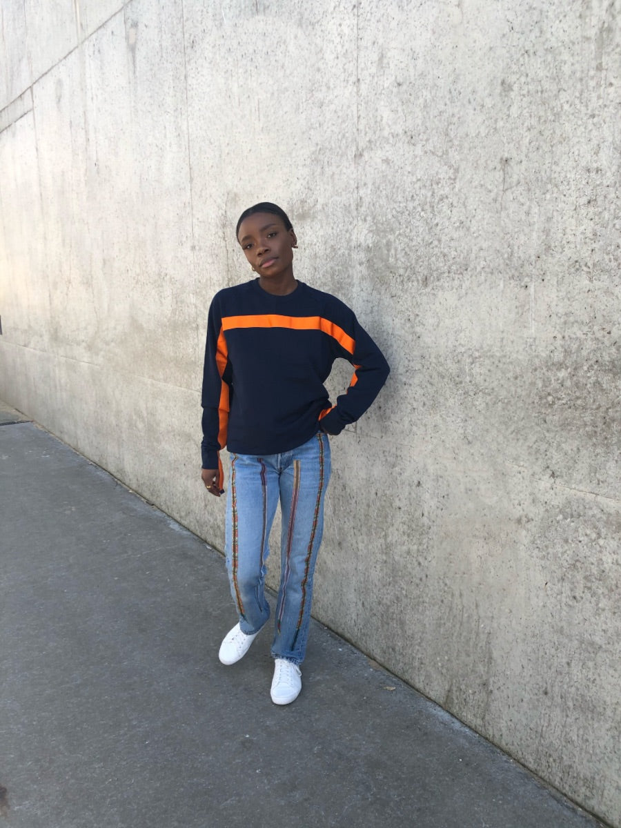 100% Gots certified organic cotton jumper in navy with an orange stripe across the chest & down the arms. Made by sustainable clothing brand Fanfare Label.