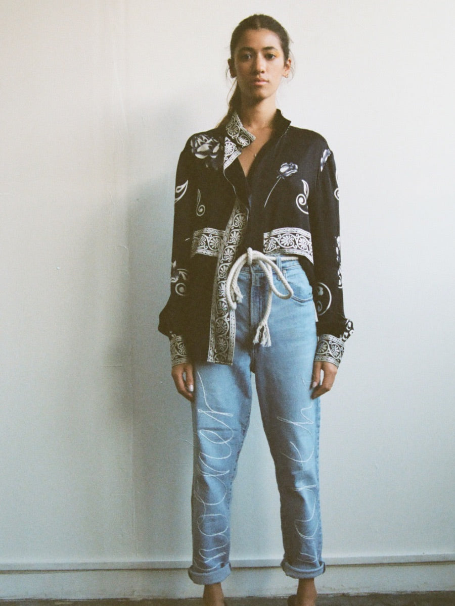 Upcycled jeans embroidered with the words 'Mother Earth'. A one-of-a-kind designer piece handmade in the UK by sustainable womenswear brand Fanfare in our ethical London factories.