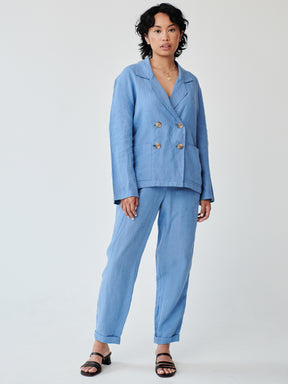 Fanfare's classic double-breasted suit with a contemporary touch. Ethically made in London this Blue Linen Suit has roll up trousers and a high waist. Perfect as a casual daytime suit or a dressed-up evening outfit, this sustainable set made in London can be worn on a variety of occasions.