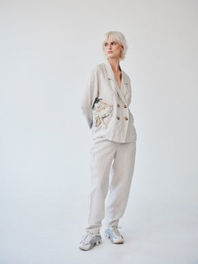 Fanfare's classic double-breasted suit with a contemporary touch. Ethically made in London this Beige Linen Suit has roll up trousers and a high waist. Perfect as a casual daytime suit or a dressed-up evening outfit, this sustainable set made in London can be worn on a variety of occasions.