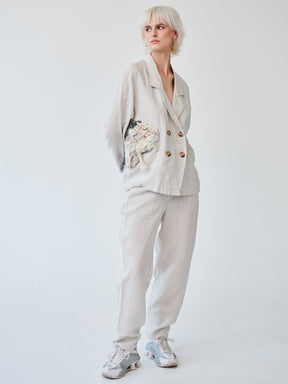 Fanfare's classic double-breasted suit with a contemporary touch. Ethically made in London this Beige Linen Suit has roll up trousers and a high waist. Perfect as a casual daytime suit or a dressed-up evening outfit, this sustainable set made in London can be worn on a variety of occasions.