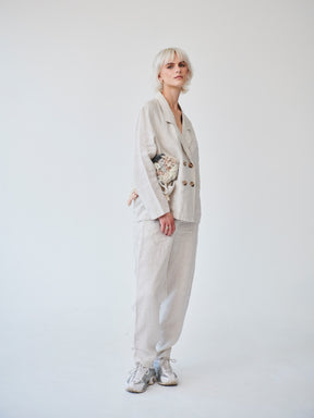 Fanfare's classic double-breasted suit with a contemporary touch. Ethically made in London this Beige Linen Suit has roll up trousers and a high waist. Perfect as a casual daytime suit or a dressed-up evening outfit, this sustainable set made in London can be worn on a variety of occasions.
