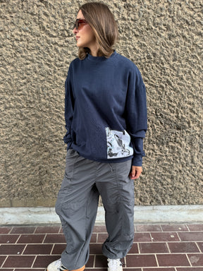 Navy oversized organic cotton jumper with oversized pleated sleeves and sustainable patches. Made by ethical clothing brand Fanfare Label.