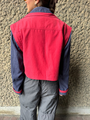 Upcycled red and navy waterproof short coat with removable sleeves, this jacket can also be worn as a gilet. Crafted by Fanfare artisans in our sustainable London-based factories.