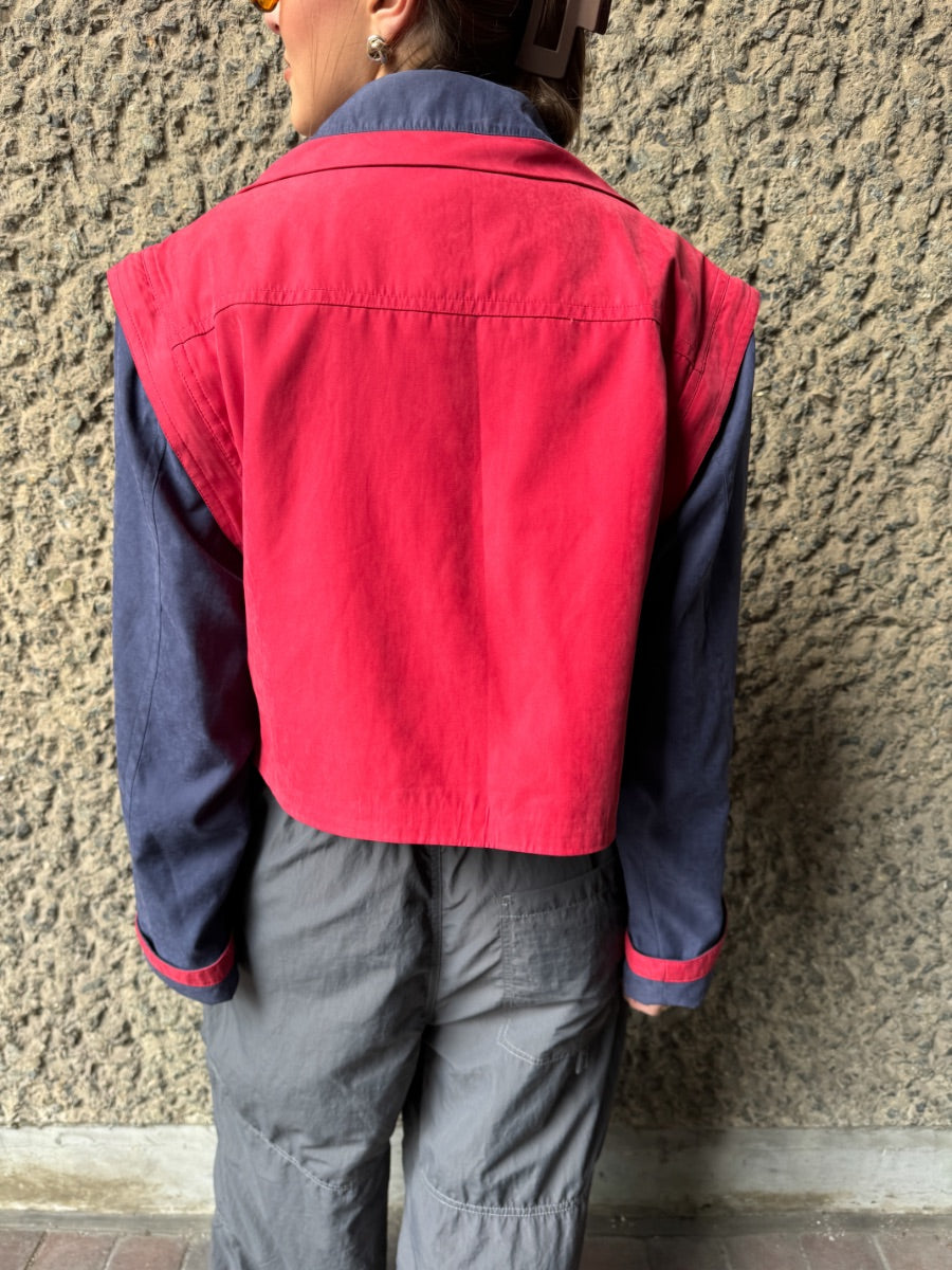 Upcycled red and navy waterproof short coat with removable sleeves, this jacket can also be worn as a gilet. Crafted by Fanfare artisans in our sustainable London-based factories.