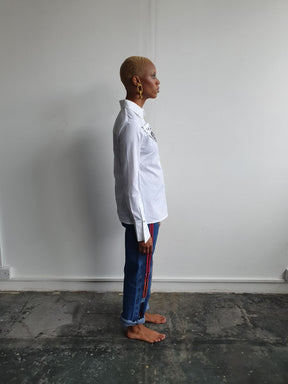 Organic Cotton White Shirt made in the UK by sustainable women's clothing brand Fanfare. This white shirt is long line, slim fit & has a detachable black printed triangle on the front.