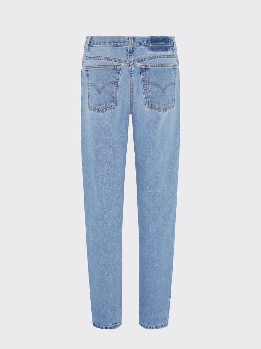 Fanfare Label sustainable women’s clothing brand UK. Our upcycled jeans are high-waisted, blue denim and made from recycled denim. We decorate every jean with a full patchwork design made from recycled materials.