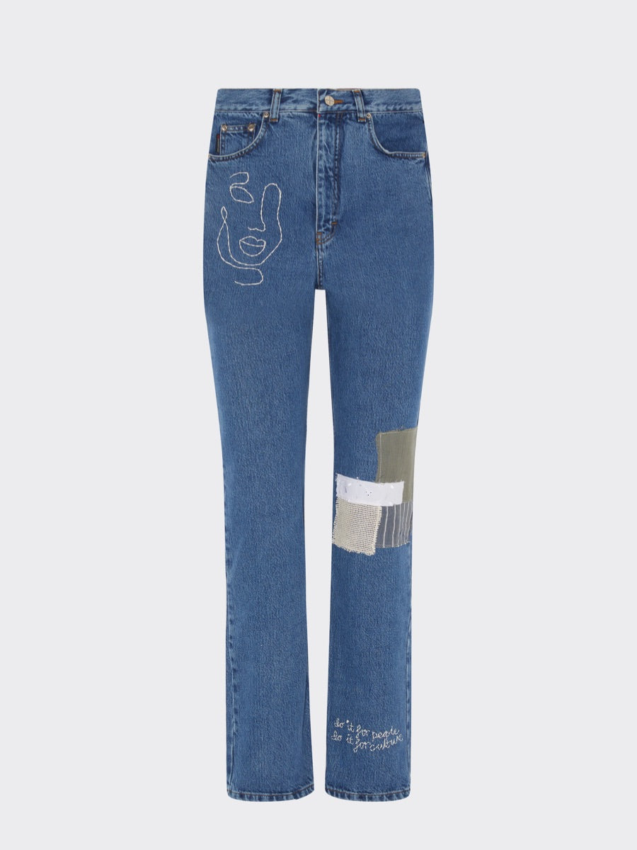 These high waisted jeans have been embroidered with an abstract face below the right pocket and patched with upcycled offcuts below the left knee. A one-of-a-kind designer piece, these jeans are hand-embroidered in Fanfare's sustainable factories based here in the UK.