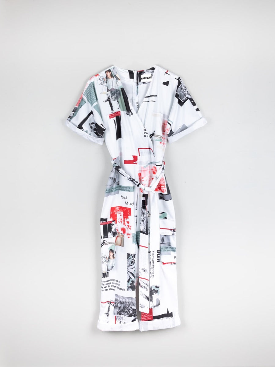 White based red & black printed jumpsuit, short sleeved with a belt. This printed white jumpsuit has sustainability activist messaging and is made by ethical clothing brand Fanfare Label