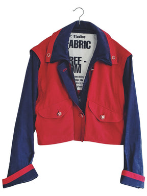 Upcycled red and navy waterproof short coat with removable sleeves, this jacket can also be worn as a gilet. Crafted by Fanfare artisans in our sustainable London-based factories.