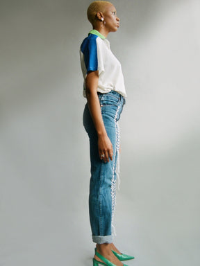 Fanfare Label sustainable women’s clothing brand UK. Our upcycled jeans are high-waisted, blue denim and made from recycled denim. We decorate every jean with white embroidery thread.