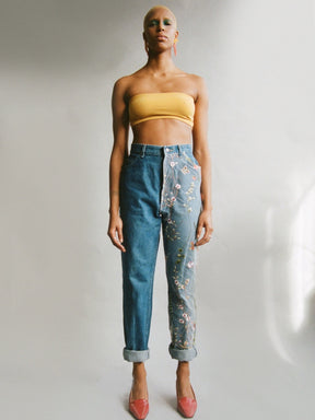 Fanfare Label sustainable women’s clothing brand UK. Our upcycled jeans are high-waisted, blue denim and made from recycled denim. We decorate every jean with embroidered fabric. 