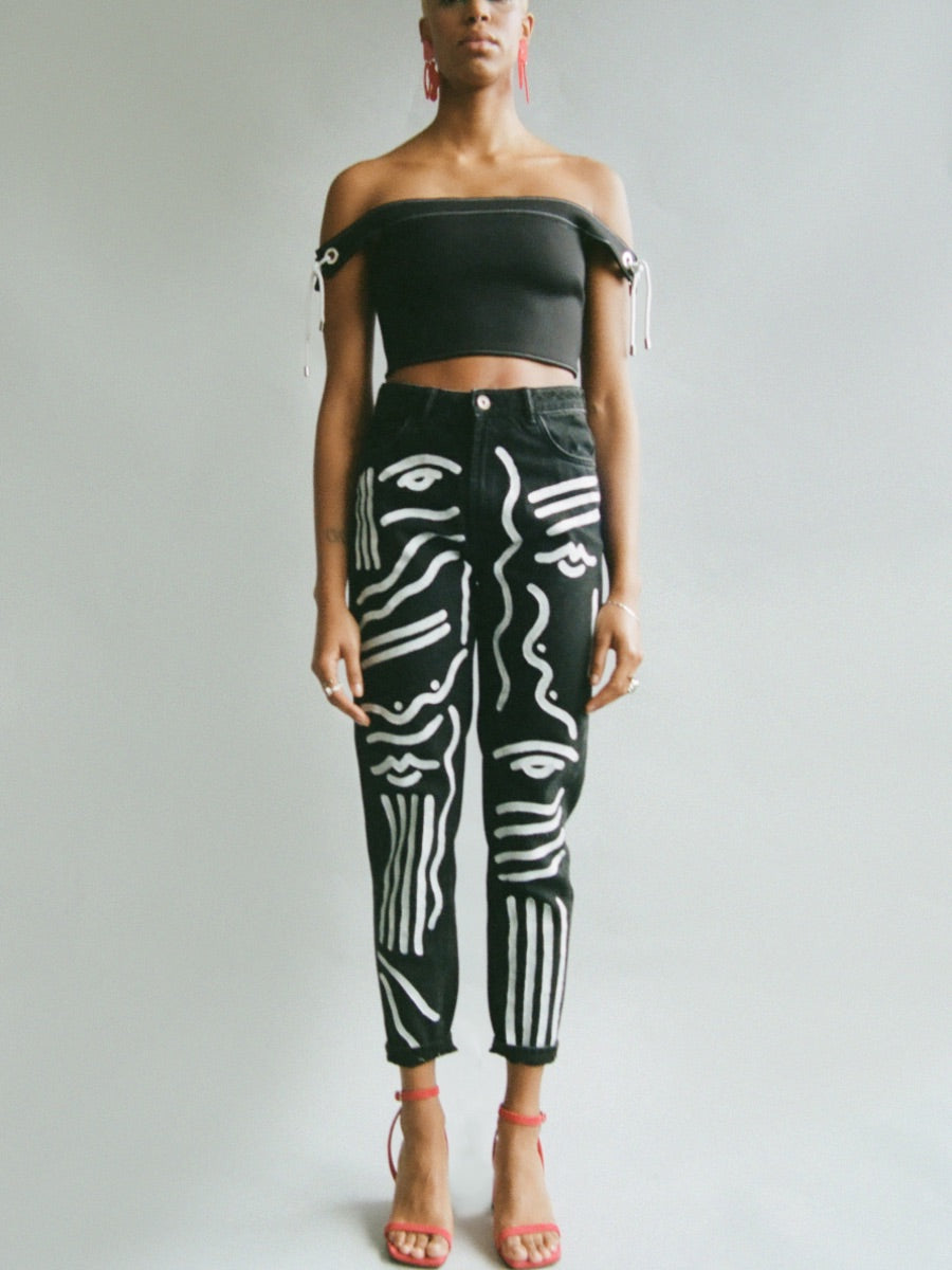These upcycled high waisted black jeans have been hand painted with white textile paint for an unique effect. Sustainably made in the UK by Fanfare Label.