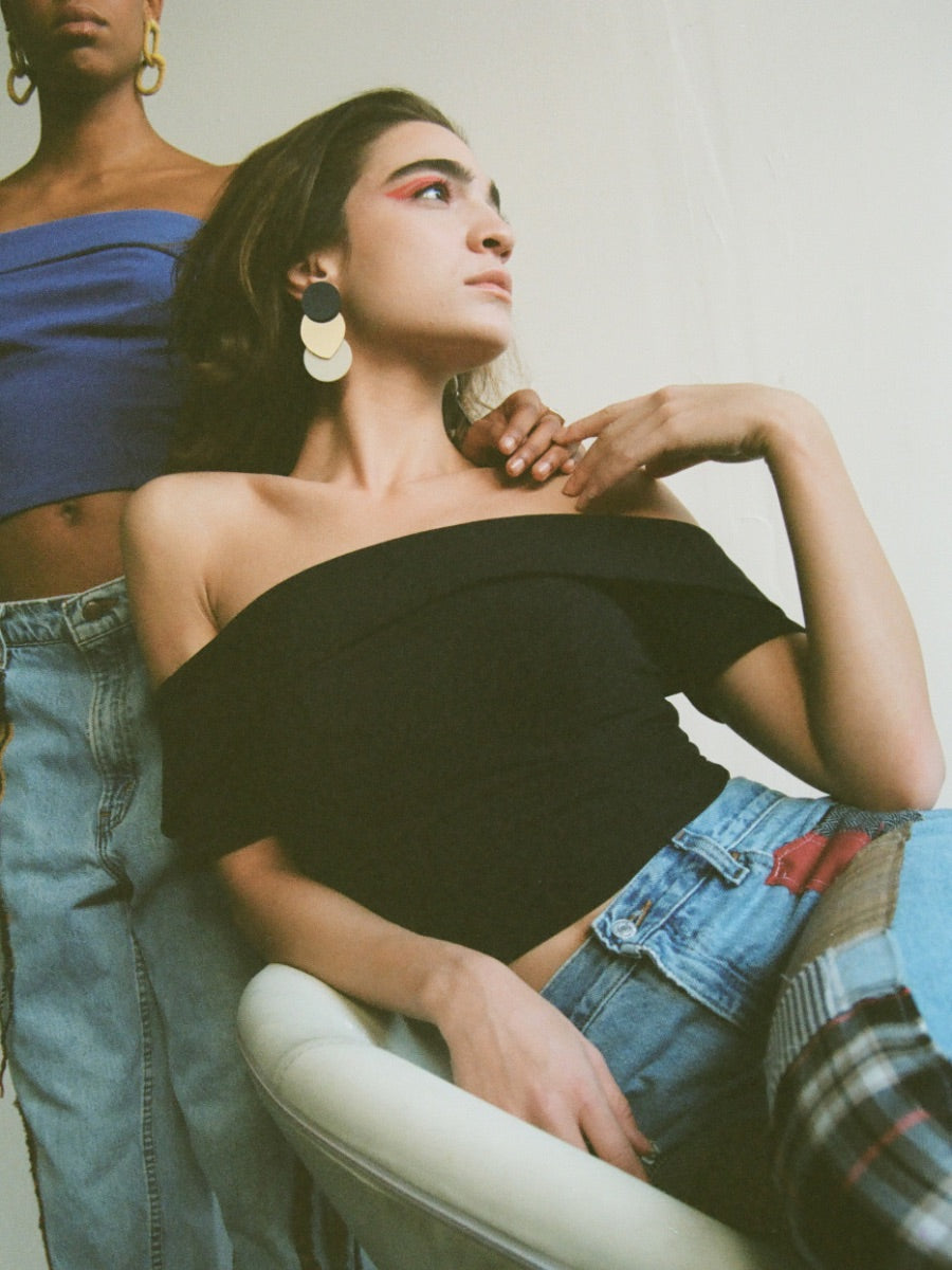 Fanfare Label sustainable women’s clothing brand UK. Our upcycled jeans are high-waisted, blue denim and made from recycled denim. We decorate every jean with a full patchwork design made from recycled materials.