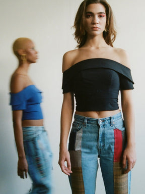 Fanfare Label sustainable women’s clothing brand UK. Our upcycled jeans are high-waisted, blue denim and made from recycled denim. We decorate every jean with a full patchwork design made from recycled materials.