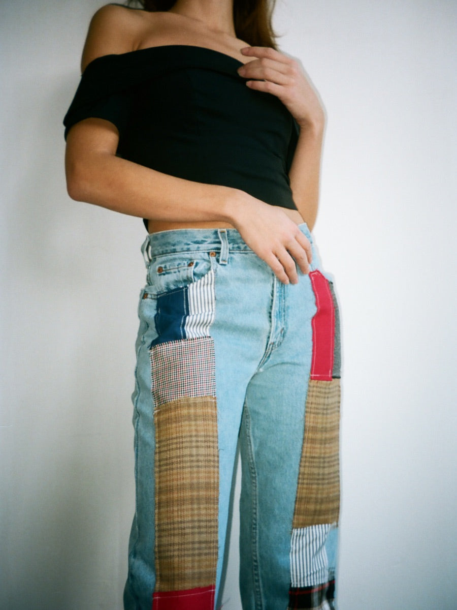 Fanfare Label sustainable women’s clothing brand UK. Our upcycled jeans are high-waisted, blue denim and made from recycled denim. We decorate every jean with a full patchwork design made from recycled materials.