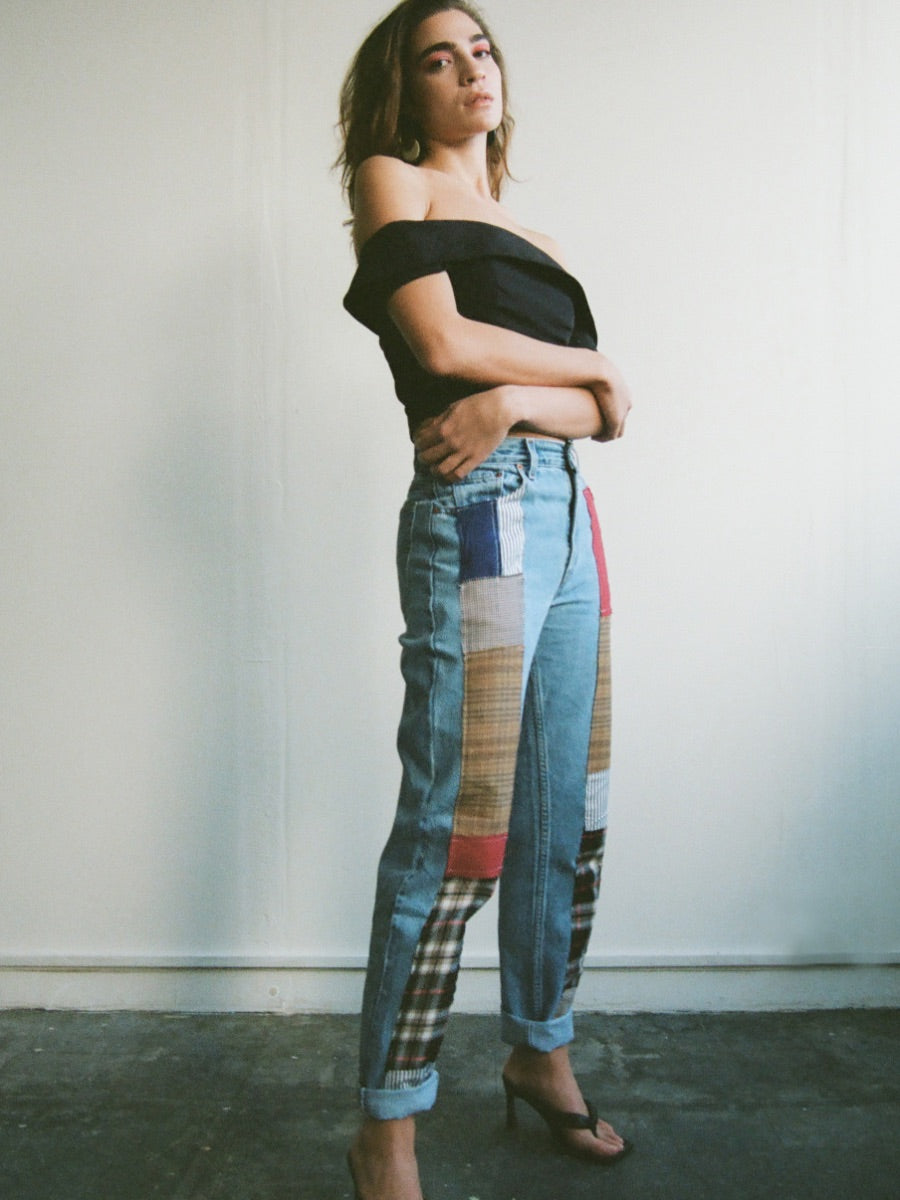 Fanfare Label sustainable women’s clothing brand UK. Our upcycled jeans are high-waisted, blue denim and made from recycled denim. We decorate every jean with a full patchwork design made from recycled materials.