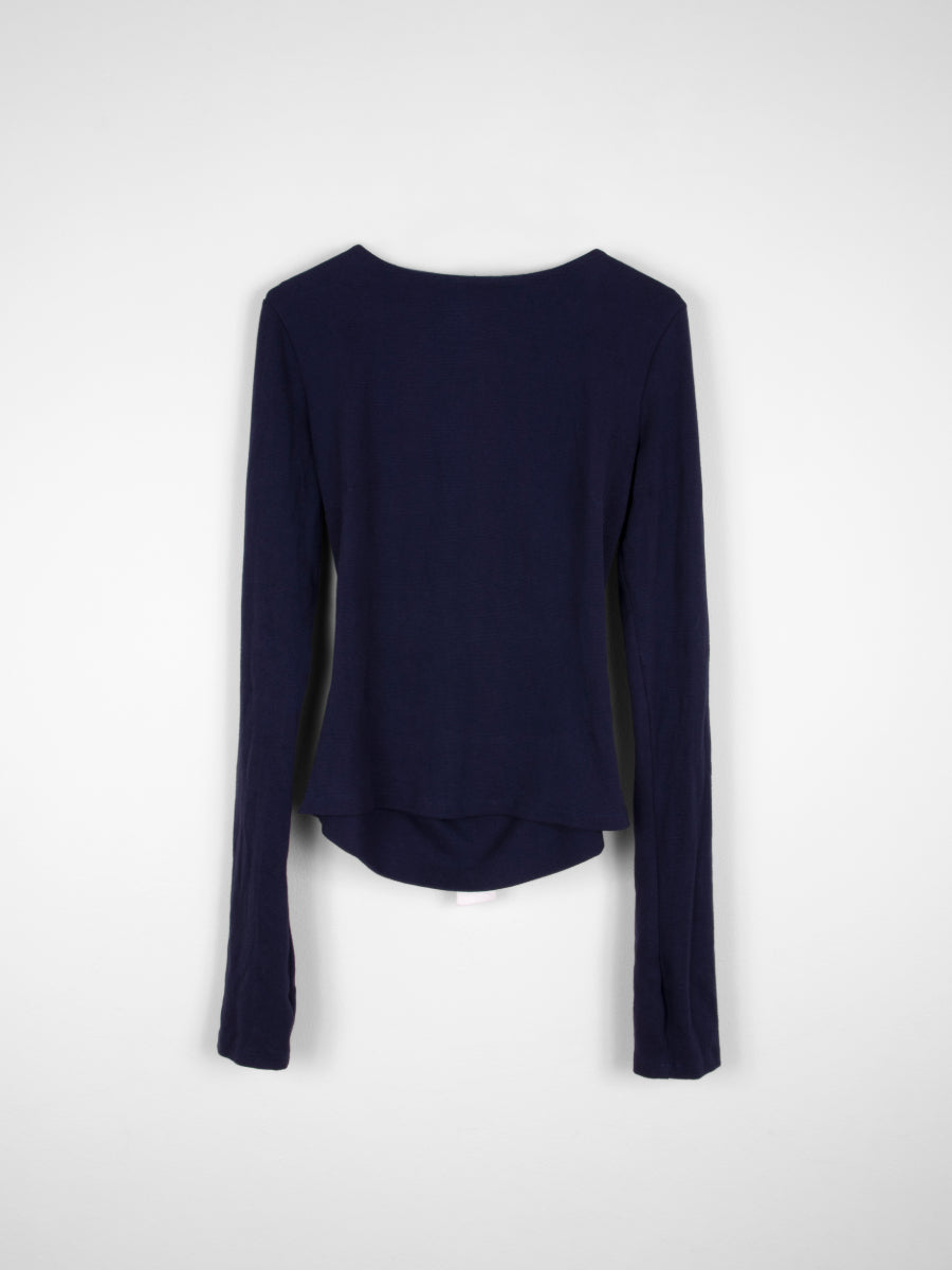 Organic cotton backless navy long sleeved jumper with white tie bow at the back. Fanfare Label Sustainable Clothing