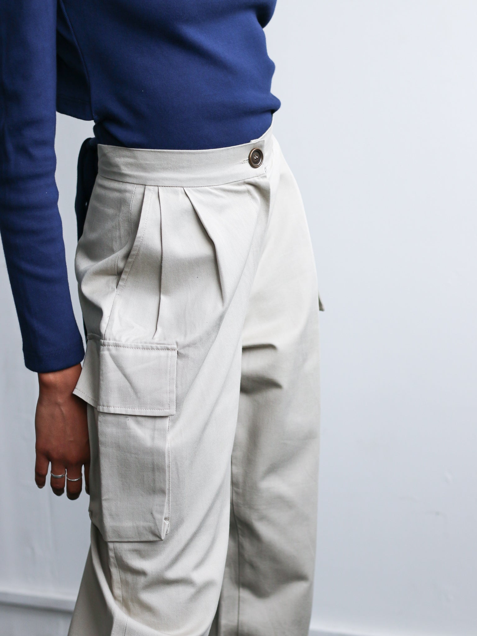 Organic Cotton Beige Utility Cargo Pant with two side pockets & buckles on the ankles. Sustainably made in the UK by ethical clothing brand Fanfare Label Edit alt text